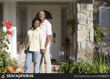 Couple Standing Outside Their House