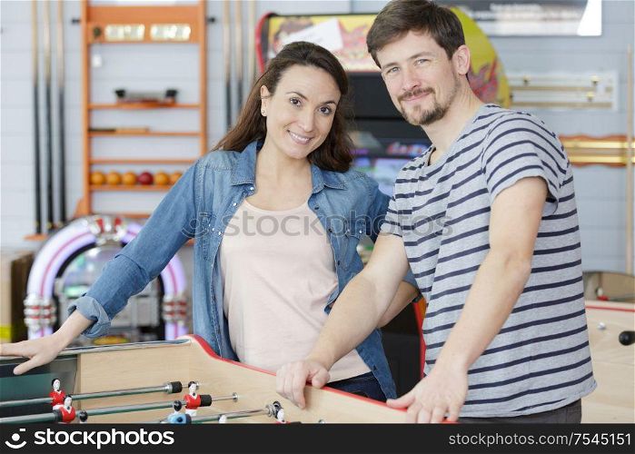 couple stod by a table football game