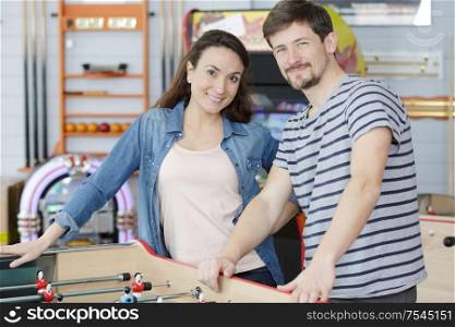 couple stod by a table football game
