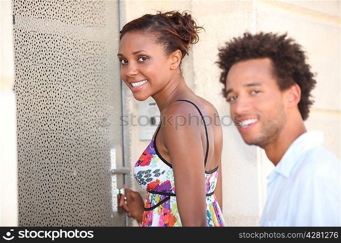 couple stood by a door