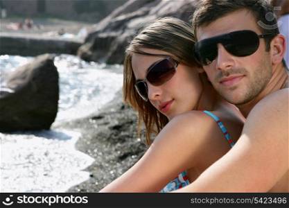 Couple stood by beach