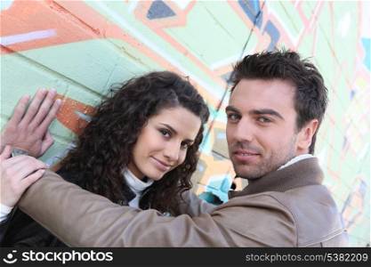 Couple stood by wall