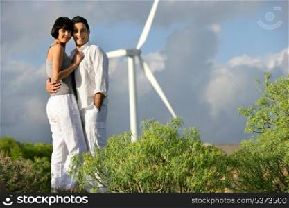 Couple stood by wind farm