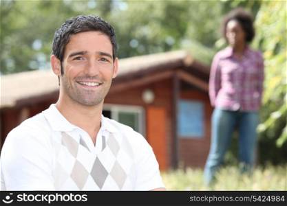 Couple stood in front of holiday home
