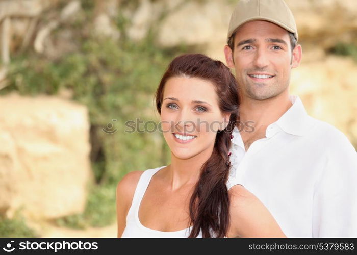 Couple stood outdoors by rocks