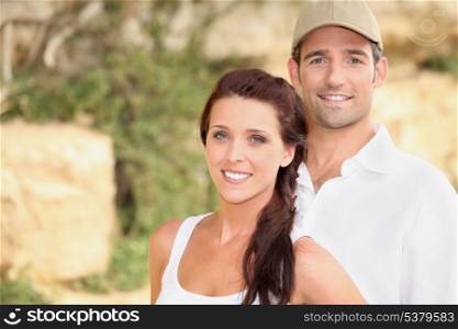 Couple stood outdoors by rocks