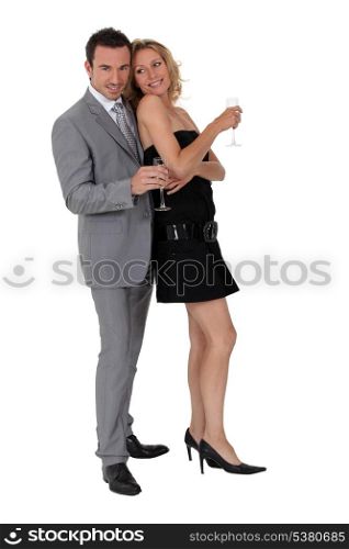 couple stood together holding champagne glasses