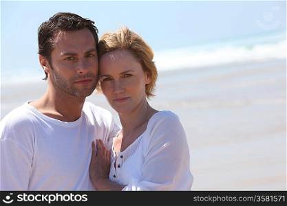 Couple stood together on a beach