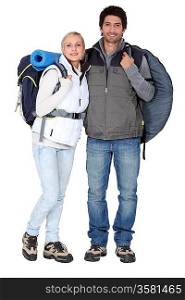 Couple stood with camping equipment