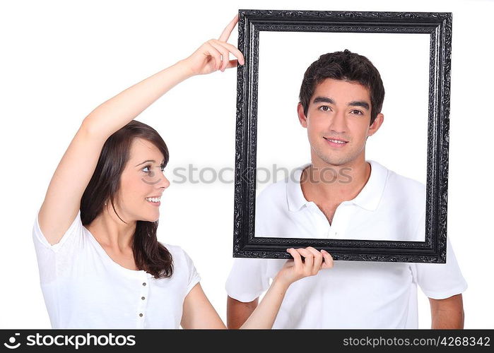 Couple stood with empty picture frame