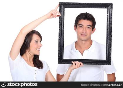 Couple stood with empty picture frame