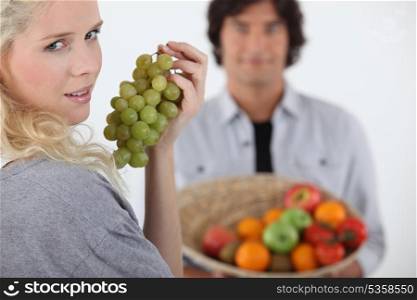 Couple stood with fruit basket