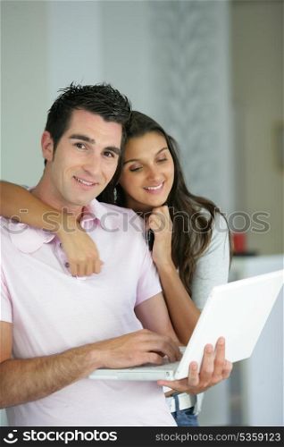 Couple stood with laptop
