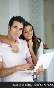 Couple stood with laptop