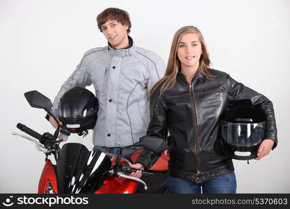 Couple stood with motorbike