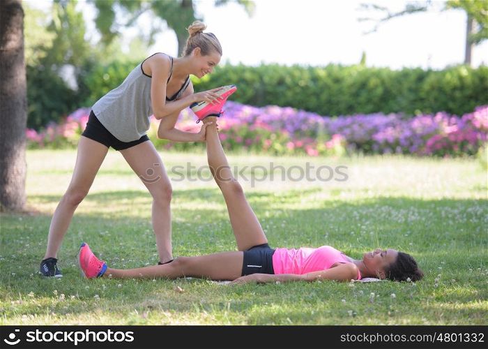 couple stretching after running in the park