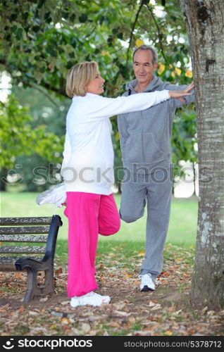 Couple stretching in a park
