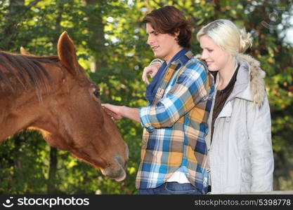 couple stroking horse