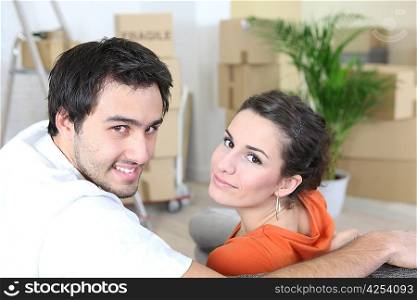 Couple surrounded by packing boxes