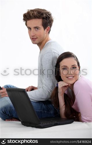 Couple taking a break from working on their laptops