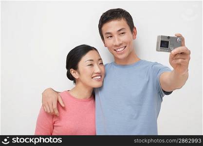 Couple Taking Photograph of Themselves