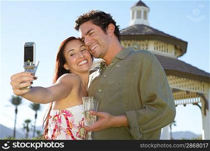 Couple Taking Photograph with Cell Phone
