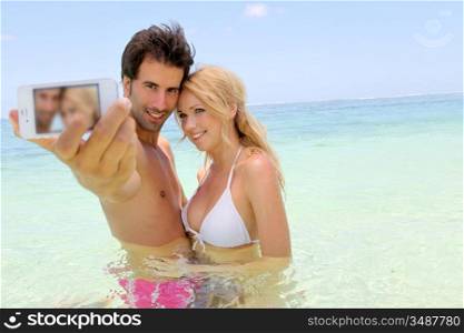 Couple taking picture of themselves in the sea
