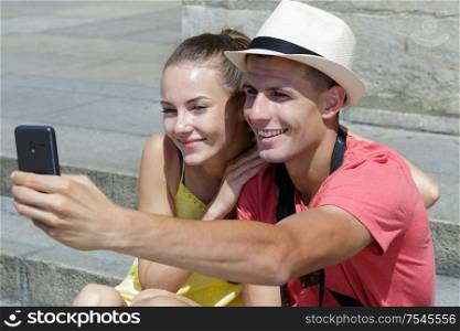couple taking self portrait with smart phone