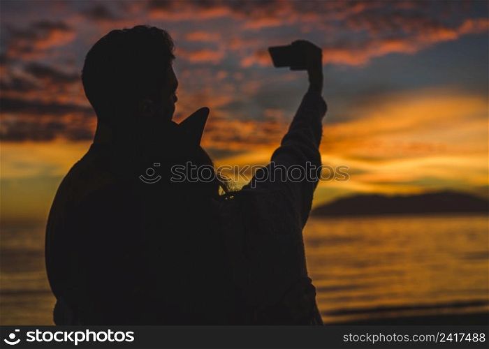 couple taking selfie night sea shore