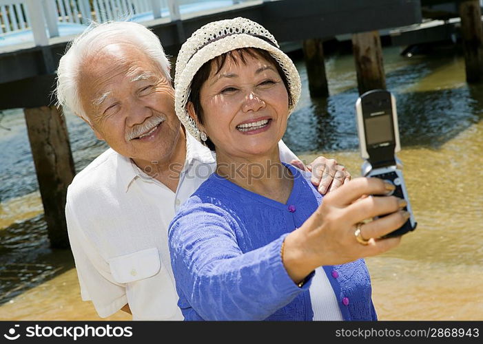 Couple Taking Their Own Photograph with Camera Phone