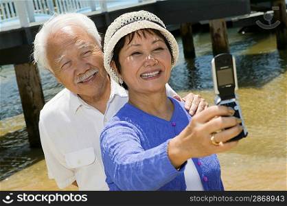 Couple Taking Their Own Photograph with Camera Phone