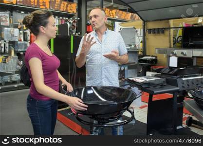 couple talking about the price of a barbecue