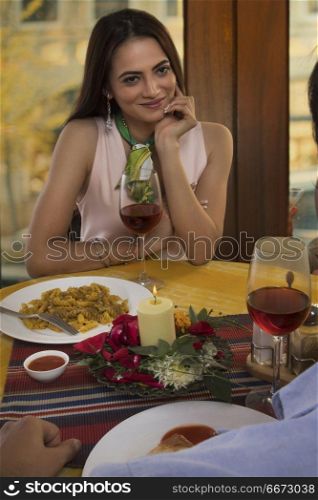 Couple talking and dining at restaurant table