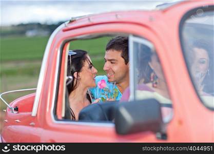 Couple talking in convertible
