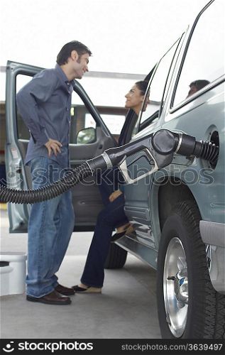 Couple talking in van with fuel pump in it
