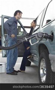 Couple talking in van with fuel pump in it