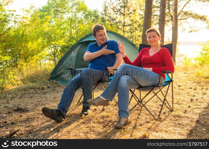 couple talking on a camping holiday