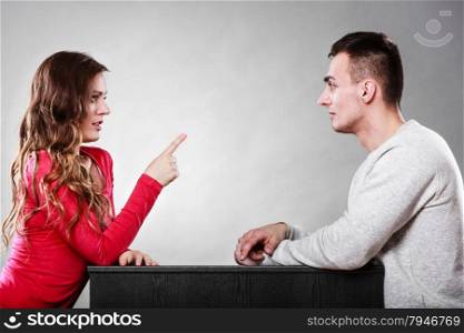 Couple talking on date. Woman warning man. Boyfriend and girlfriend having conversation. Girl threatening with finger.. Woman warning man. Girl threatening with finger.