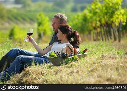 Couple tasting wine at a vineyard