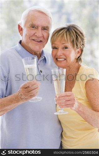 Couple toasting champagne and smiling
