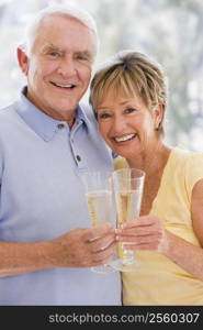 Couple toasting champagne and smiling