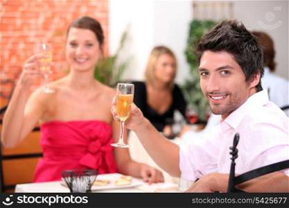 Couple toasting in restaurant