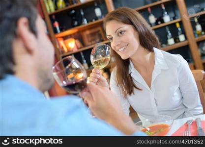 couple toasting wineglasses in a luxury restaurant