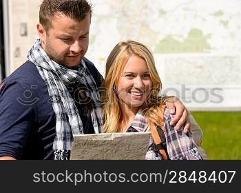 Couple together on holiday with map happy tourists directions trip