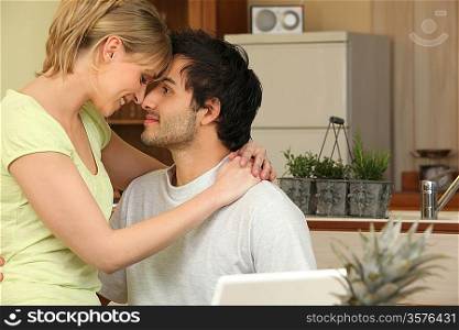 Couple touching foreheads at home