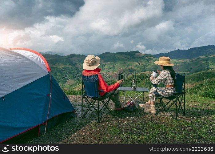 Couple tourists enjoying in the c&ing on mountains