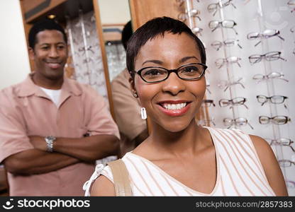 Couple trying on eyeglasses in store