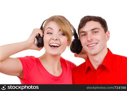 Couple two friends with big headphones listening to music mp3 together. Joyful happy woman and man on white. People leisure happiness concept. . Couple two friends with headphones listening to music