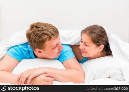 couple under blanket looking at each other