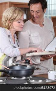 Couple using a recipe book